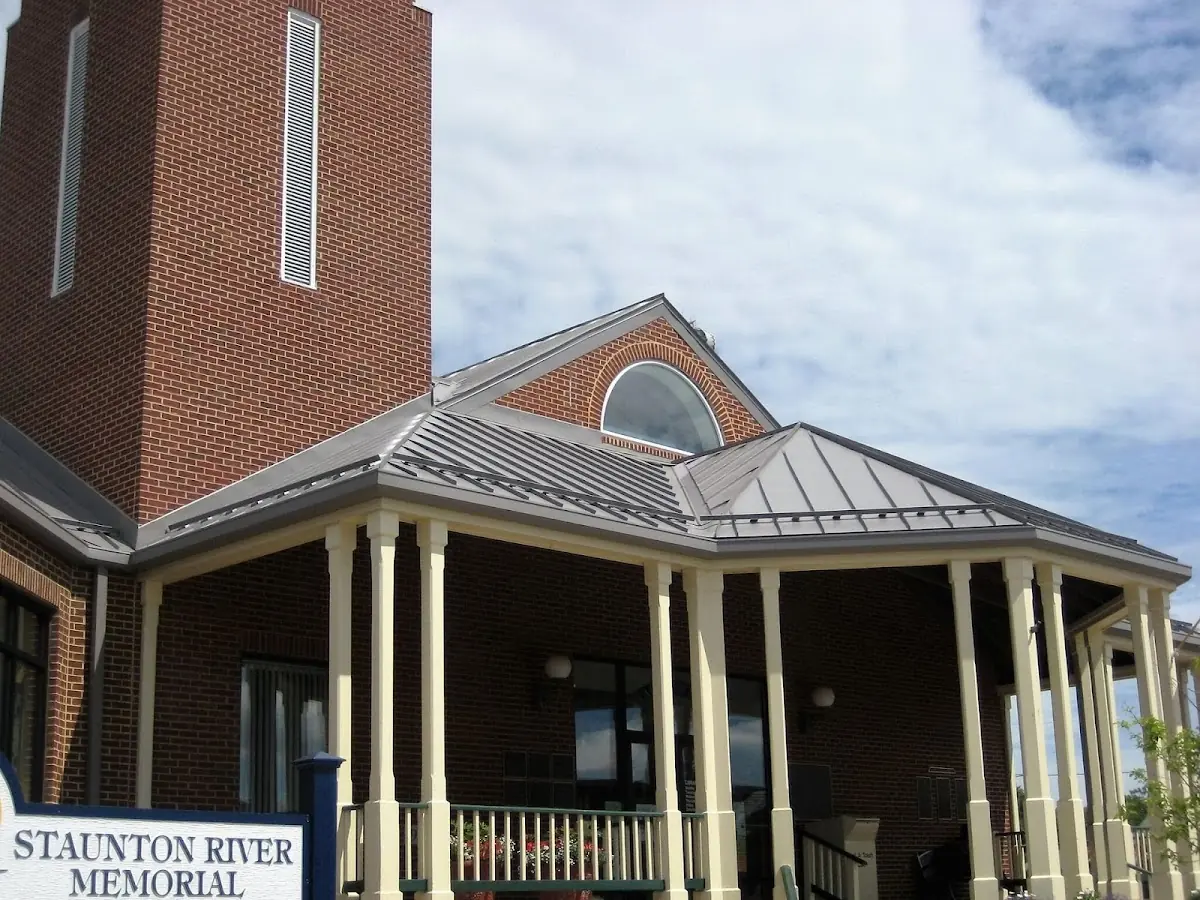 Skilled roofing craftsmen working on a residential roof in Saint Michael